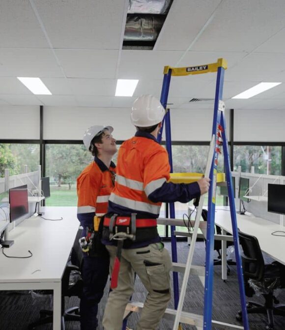 two adelaide commercial electricians working on office upgrades
